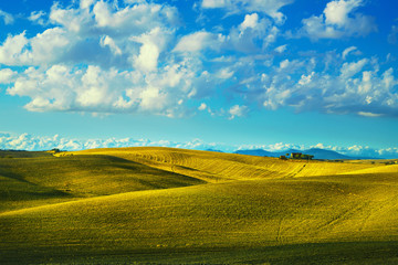 Tuscany countryside panorama, rolling hills and fields on sunset. Pisa, Italy