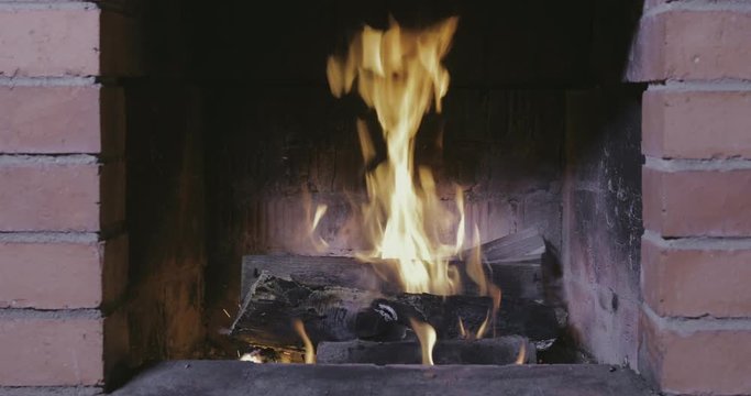 Firewood burns in a fireplace