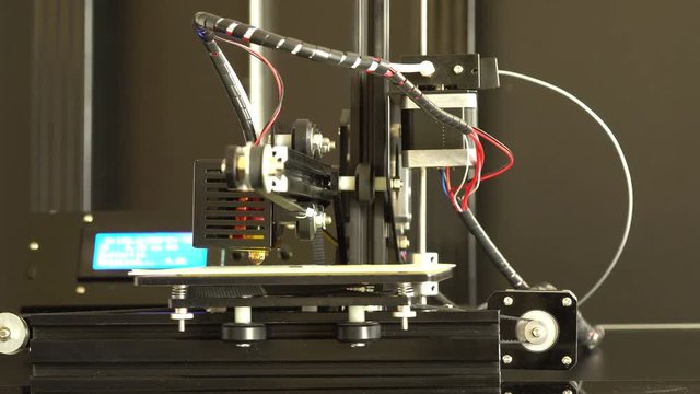 3D printer prints Prototype mechanical parts out of plastic filament