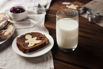 Slices of homemade cake and glass of milk on wooden background, morning concept