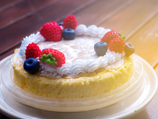 Close up. Creamy mascarpone cheese cake with strawberry and winter berries. Japanese Cheesecake. Close up. Christmas dessert. Healthy food. Creative atmospheric decoration.