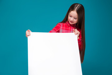 Cute little girl in checkered shirt with brunet hair hold clear paper