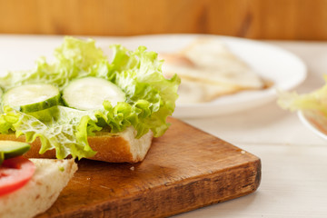 Sliced tomatoes, cucumber and salad leaves on a fresh ciabatta bread