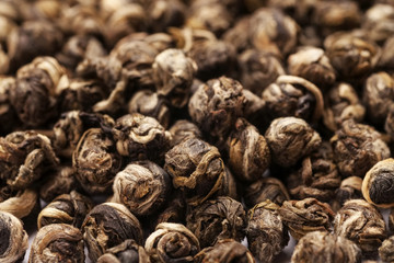 Macro shot of dry green tea balls, abstract texture