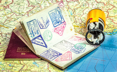 Travel concept - stamps in the passport + rubber stamp on the map