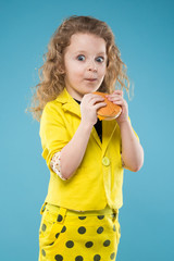 Cute young girl dressed all in yellow with burger