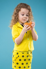 Cute young girl dressed all in yellow with burger