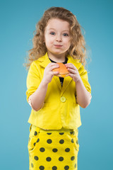 Cute young girl dressed all in yellow with burger