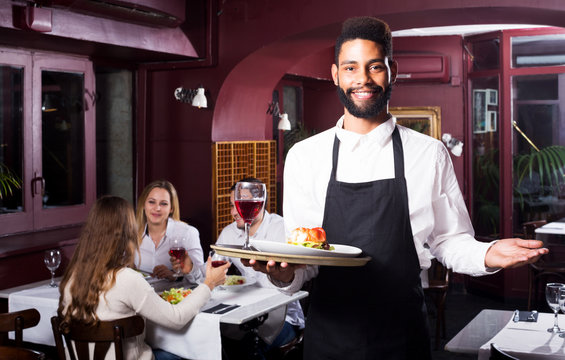 Middle class restaurant and cheerful waiter