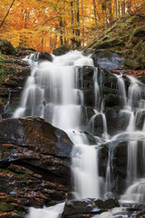 Fototapeta na wymiar Landscape of waterfall Shypit in the Ukrainian Carpathian Mountains on the long exposure in autumn