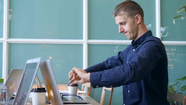 Funny Programmer Geek Puts on Glasses, Flexes His Hands and Begins Typing Crazy Fast on Laptop in the Office. 4K.