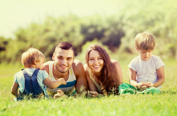 Fototapeta premium Family of four in sunny park