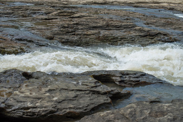 Shallow stone rapids of a mountain river