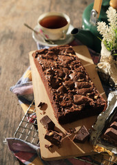 abstract topping chocolate brownies sliced cake with black tea and chocolate bar