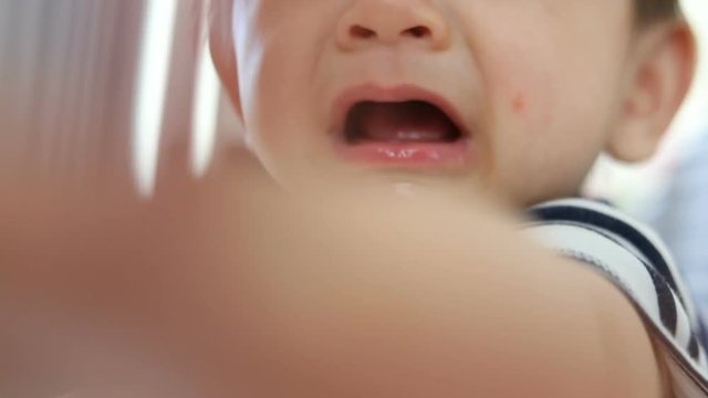 baby boy crying with tears, unhappy feeling, slow motion shot