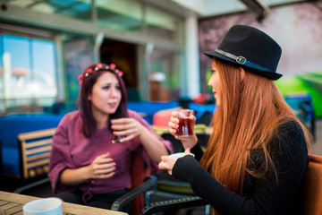 Beautiful girl drinking coffee at the coffee shop
