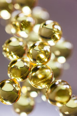 yellow capsules on mirror background