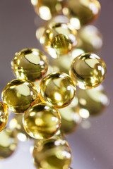 yellow capsules on mirror background