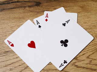 Four aces cards on wood background - Success concept