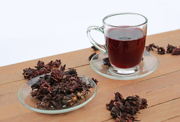 Roselle juice with dried roselle on wooden plank.