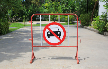 Metal partition on the road with traffic sign. Do not enter sign.