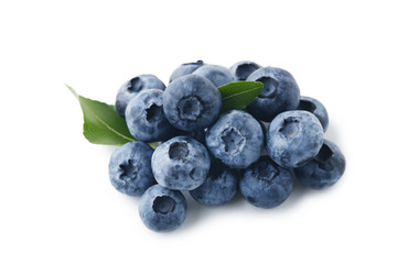 Ripe blueberries with green leafs isolated on white background