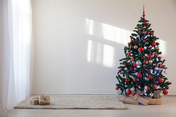 Christmas tree in a white room for Christmas with gifts