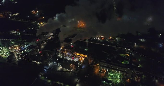 Night aerial shot of  the oil refinery. Lots of lights. Industrial areal.