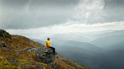 Man sitting on a mountain and thinks