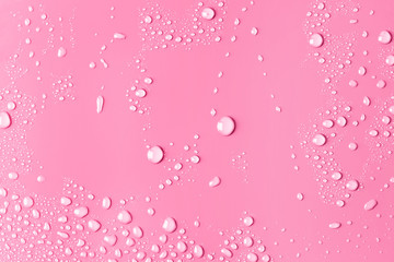 Close-up of water drops on pink surface	