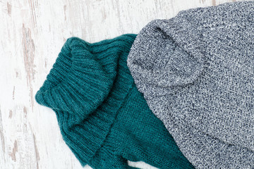 Two warm sweater with neck. Green and gray. Close up