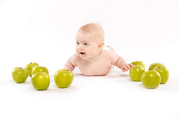 Fototapeta na wymiar baby lying surrounded by apples