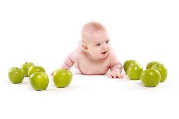 Fototapeta na wymiar little boy surrounded by green apples