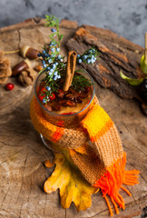 Hot drink with honey and spices on wooden background concept of seasonal postcard