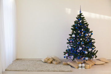 Christmas tree on Christmas day in a white room with gifts