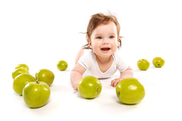 Fototapeta na wymiar funny baby surrounded by green apples