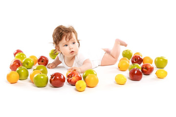 Fototapeta na wymiar little boy surrounded by fruit