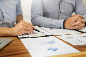 Team work process. young business managers crew working with new startup project. labtop on wood table, typing keyboard, texting message, analyze graph plans.