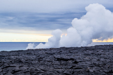 Fototapeta na wymiar Eruption of a volcano on the Hawaiian island on the ocean. Volcanic activity. Tourism. Field of frozen black lava