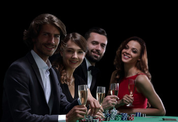 side view of group of people playing poker together in casino