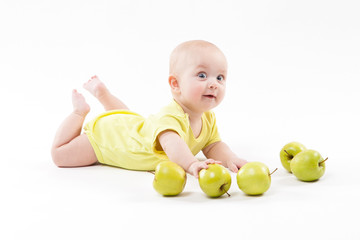 Fototapeta premium Cute curious baby lies on her stomach and looking at the camera