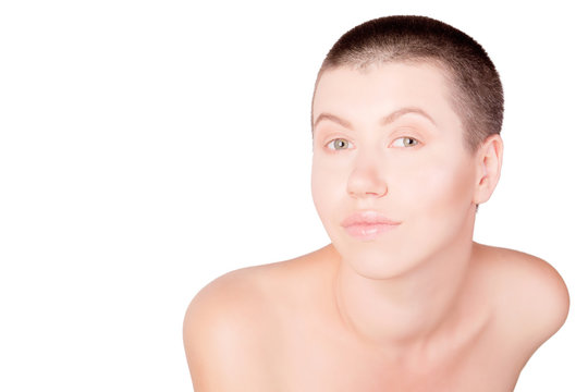 Portrait of positive woman with bald haircut with bare shoulders on isolated white background