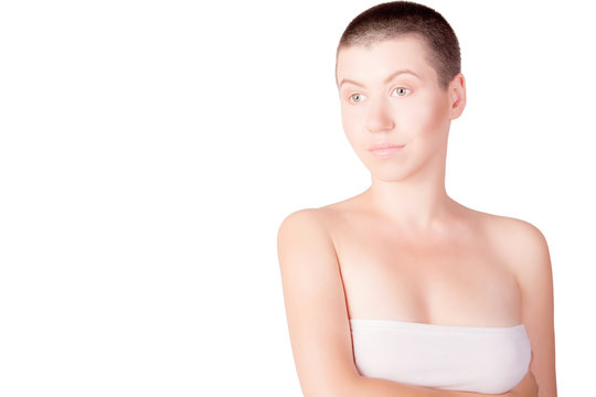 Portrait of woman with bald haircut with bare shoulders on isolated white background