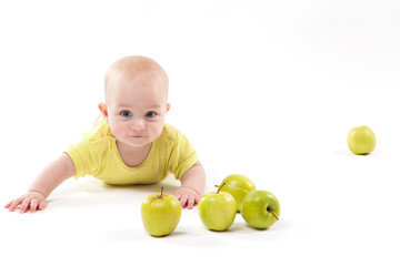 Fototapeta na wymiar smiling baby lying on the background to include apples