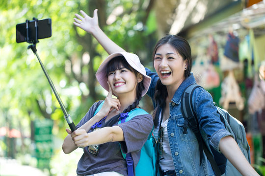 Portrait of Happy traveler Woman Selfie with friend together in city. Asian women using Smartphone with Happy emotions, Woman with Travel Concept.