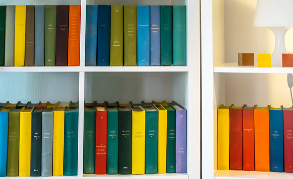 The Books On A White Shelf In A Room