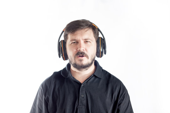 Portrait of 30 years old caucasian man singing song from headphones