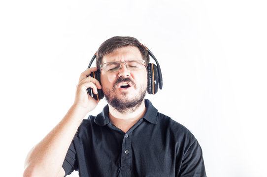 Portrait of 30 years old caucasian man singing song with headphones