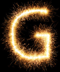 Sparkler firework light alphabet G isolated on black