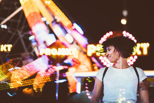 Excited model posing in illuminated night park
